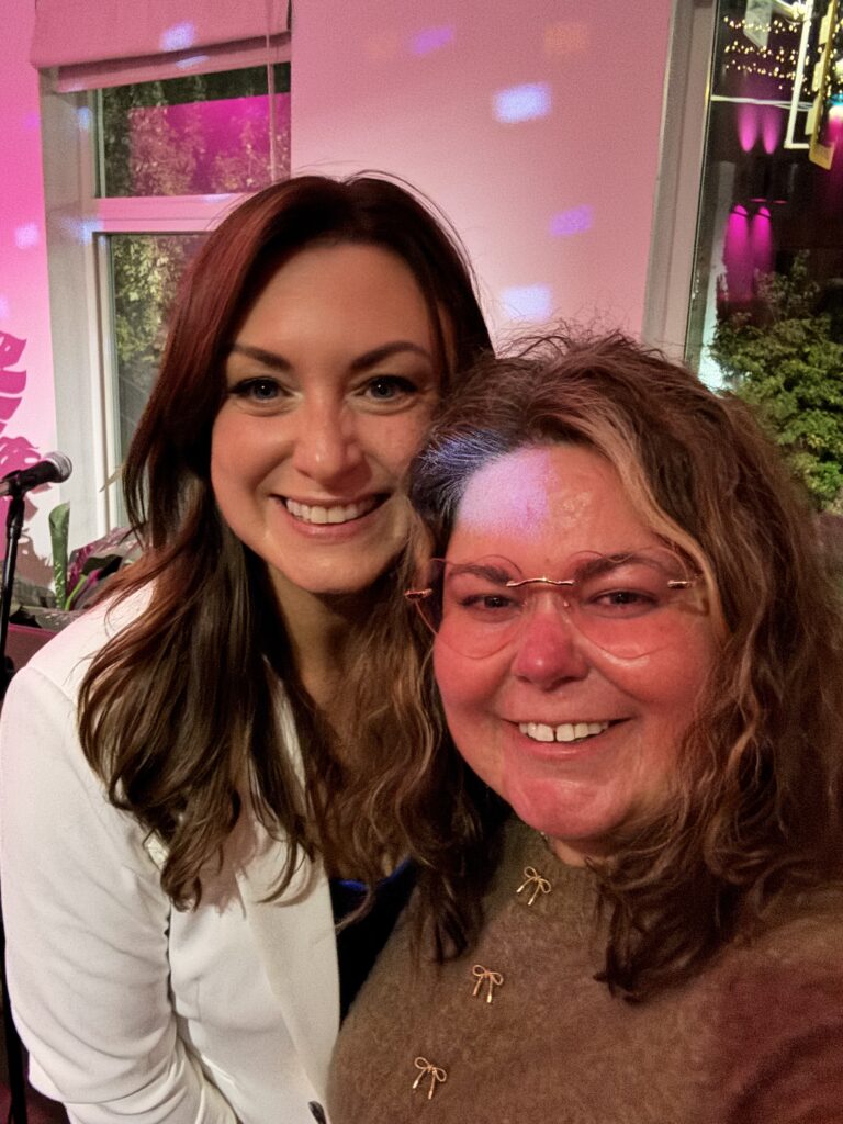 Crystal Adair-Benning with a client at an evening book event